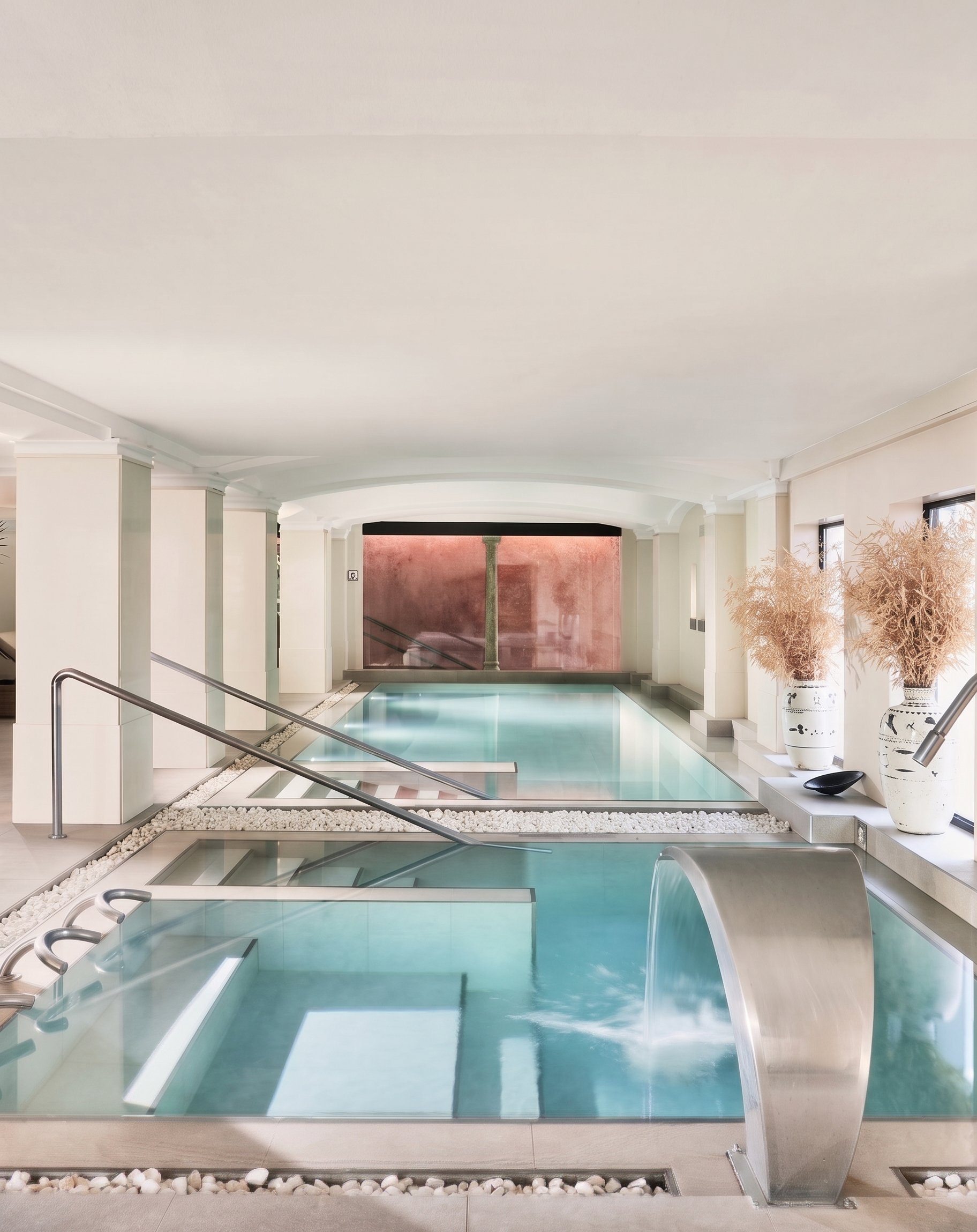 The flow spa's indoor water circuit with counter-current pool and stone waterfall feature